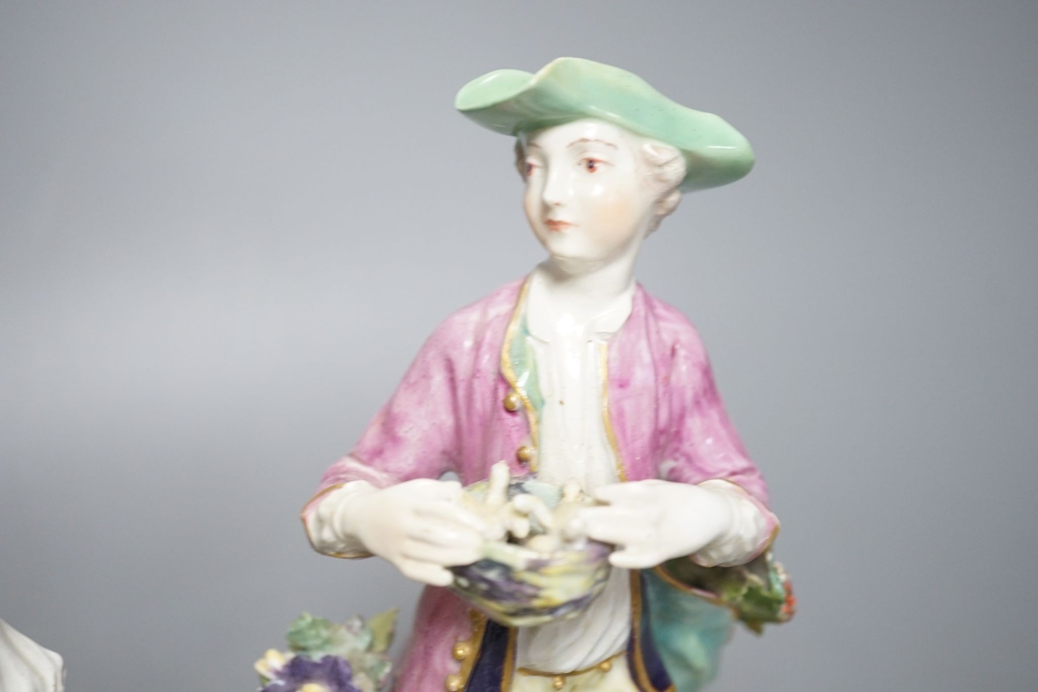 Two Derby porcelain figures of a gentleman holding a bird’s nest and a lady with a sheep, c.1760, 21.5 cms high.